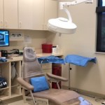 A dental treatment chair and light.